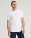 Man wearing a plain white t-shirt against a light gray background