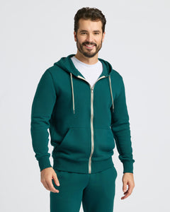 True ClassicMan in Deep Emerald Fleece French Terry Zip Hoodie, smiling slightly.