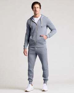 True ClassicMan models Dusty Blue Fleece French Terry Zip Hoodie, hands in pocket.