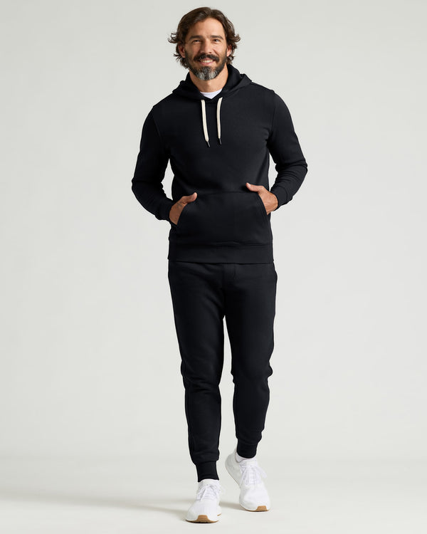 Variety Long Sleeves 3-Pack shown on a smiling man wearing a black hoodie and joggers with white sneakers for a men's basics look
