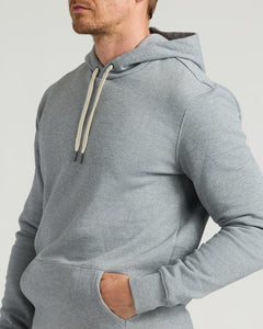 True ClassicClose-up of a man wearing a Dark Heather Gray Fleece French Terry Pullover Hoodie with a kangaroo pocket and adjustable drawstrings.