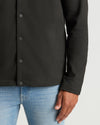Black Casual Jacket over jeans, highlighting its slim fit and structured look.