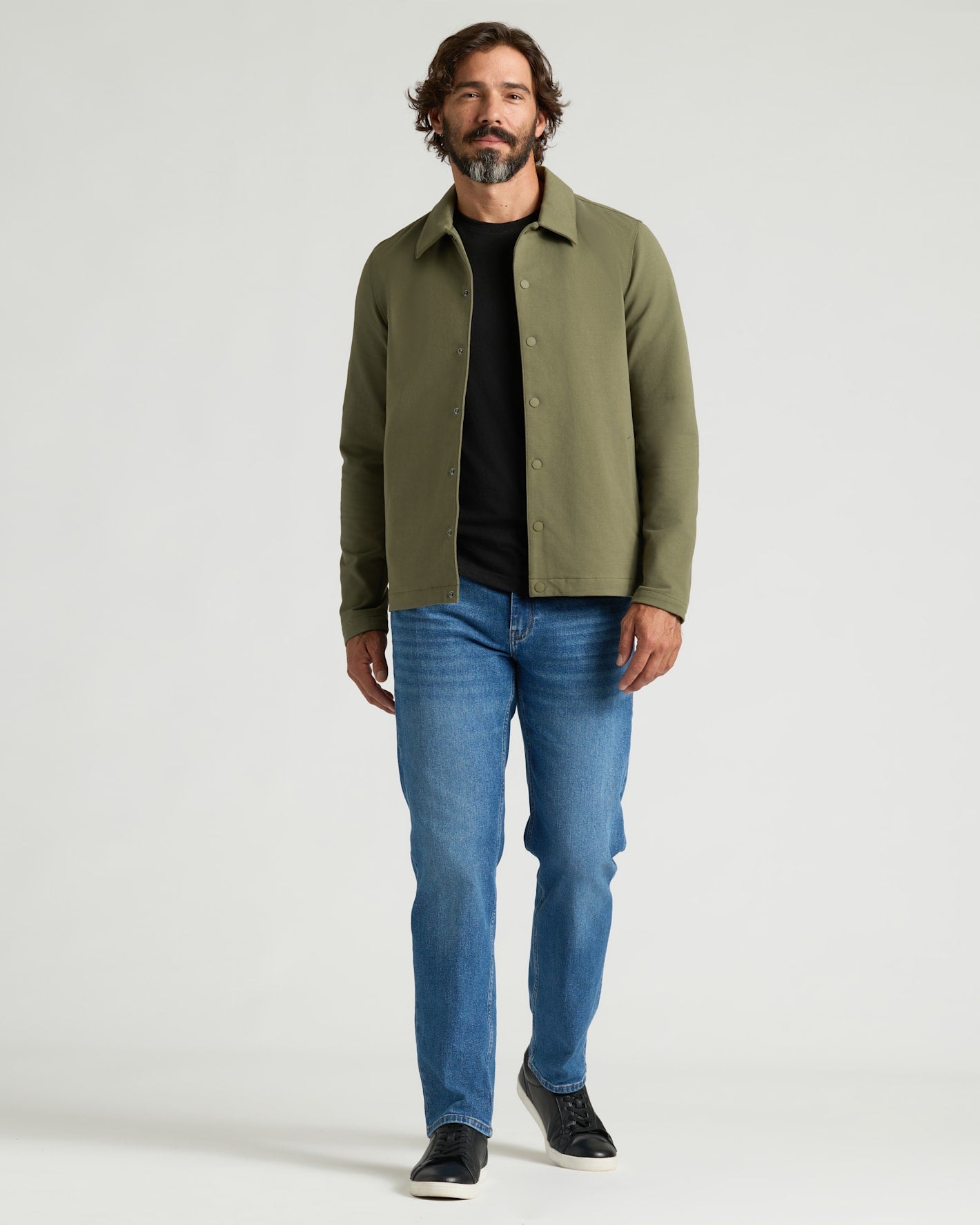 Man wearing Military Green Casual Jacket with black tee and jeans.