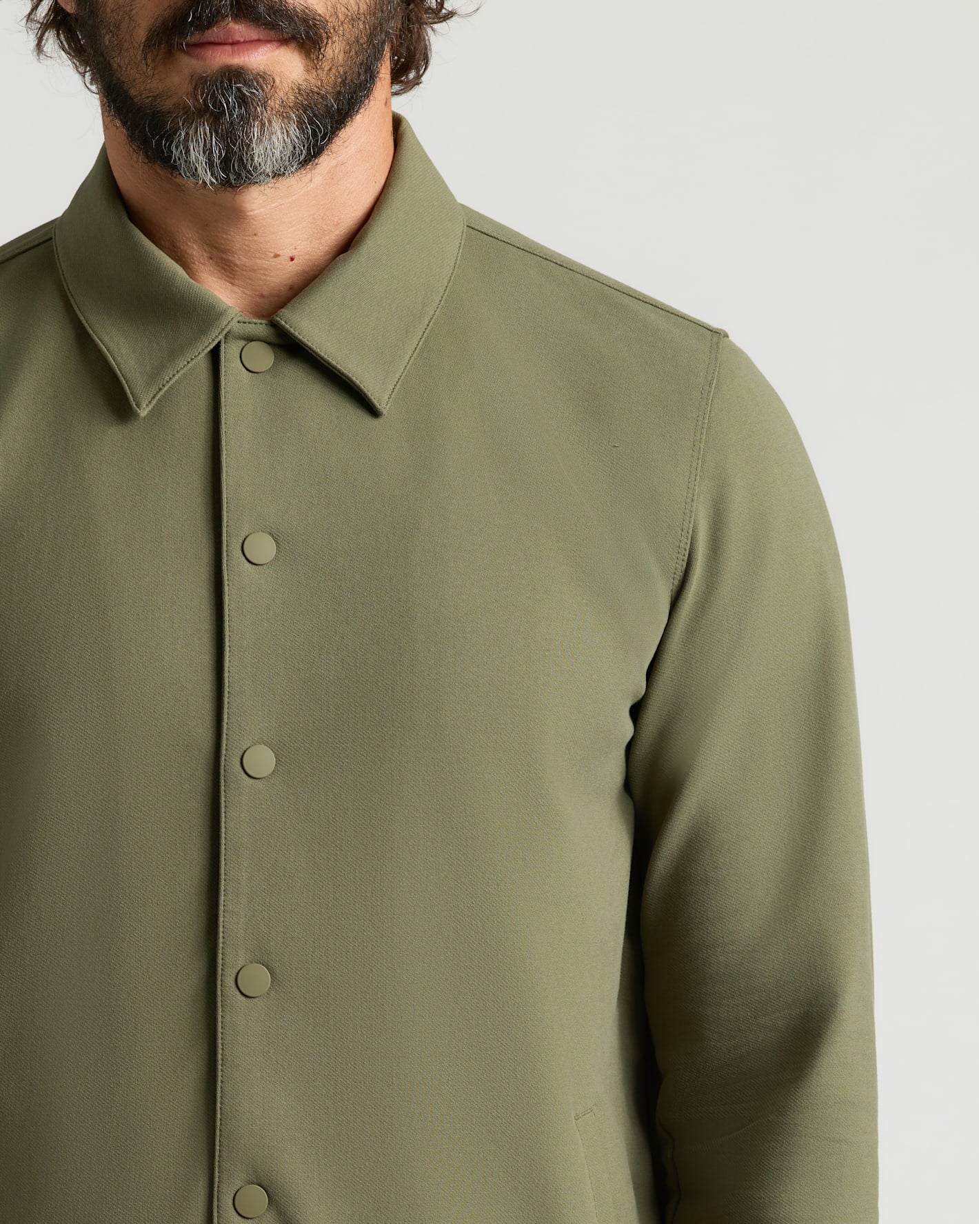 Man wearing Military Green Casual Jacket with snap buttons and pointed collar.