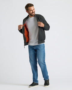 True ClassicMan wearing a dark jacket with a red lining, white shirt, blue jeans, and black shoes on a light gray background