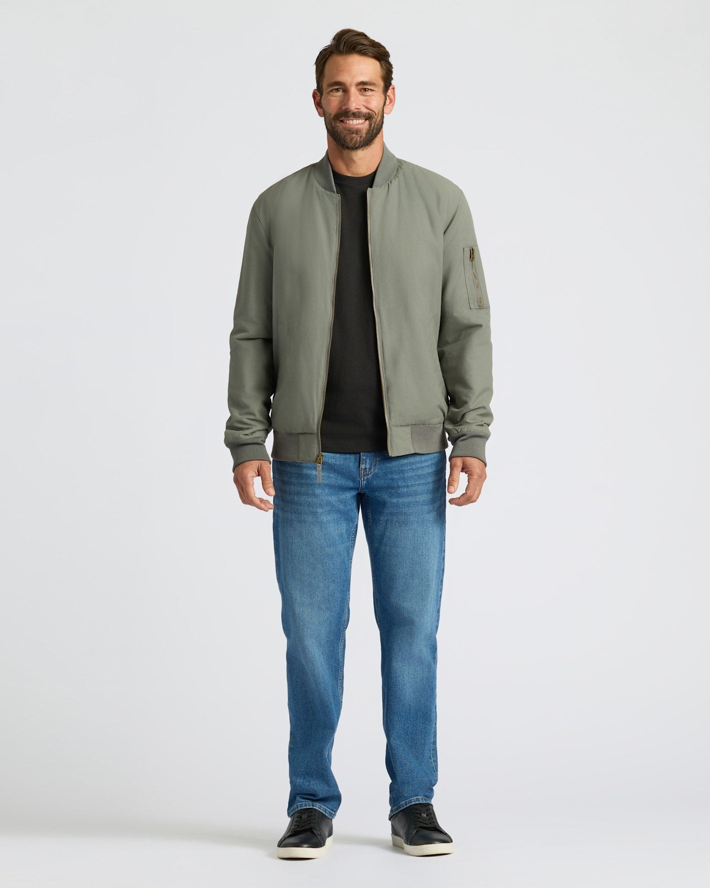 Man wearing Carbon Bomber Jacket with jeans and sneakers.