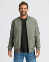 Man wearing Carbon Bomber Jacket with front zip and sleeve pocket.