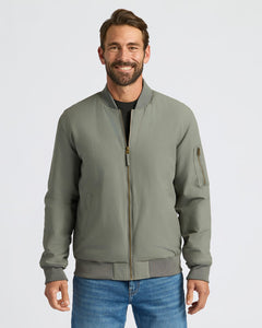 True ClassicCarbon Bomber Jacket worn with jeans and a black T-shirt.