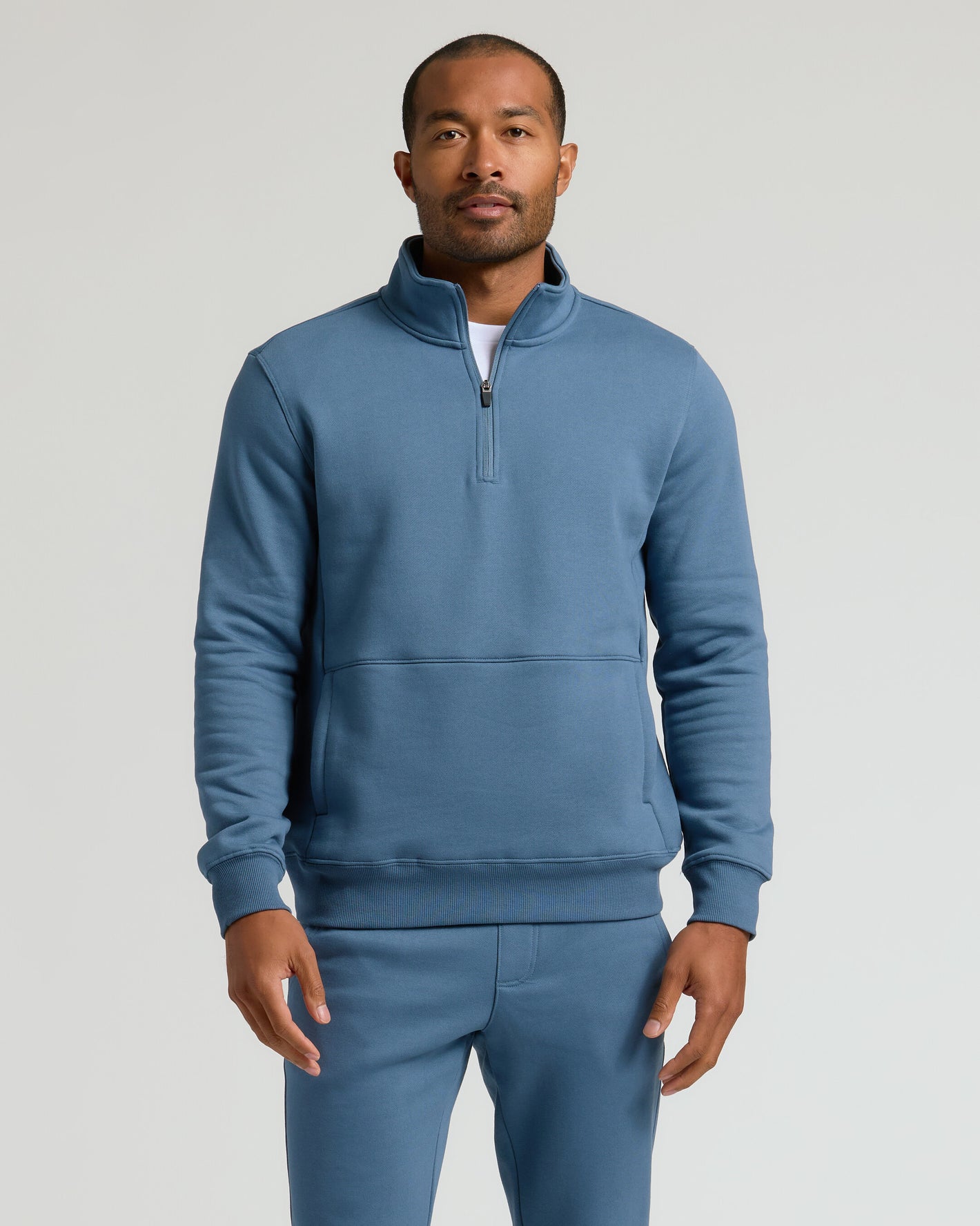 Man modeling Fiord Half Zip Fleece Sweatshirt with joggers.