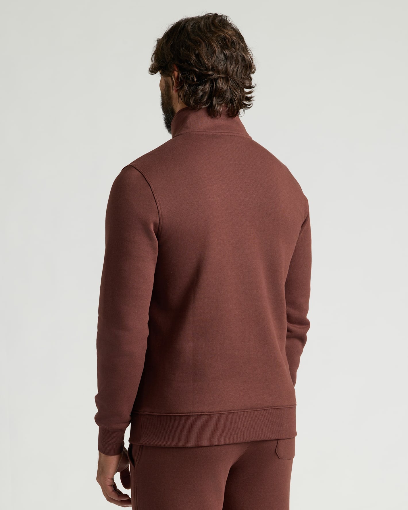 Man wearing Carob Half Zip Fleece Sweatshirt & Jogger 2-Pack, rear view.