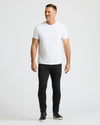 Man wearing a white t-shirt and black pants on a white background