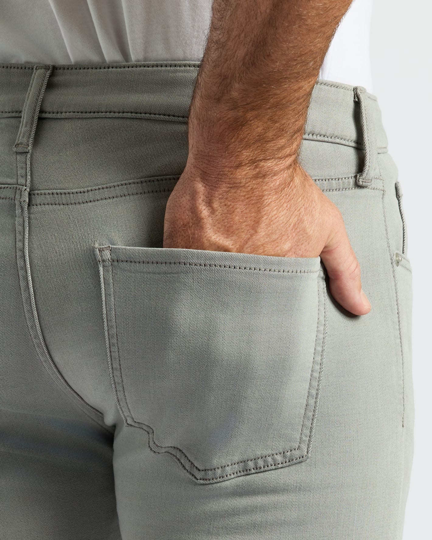 Medium Gray Wash Slim Comfort Stretch Jeans shown on a person’s hip.