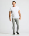 Man wearing Medium Gray Wash Slim Comfort Stretch Jeans, white T-shirt.