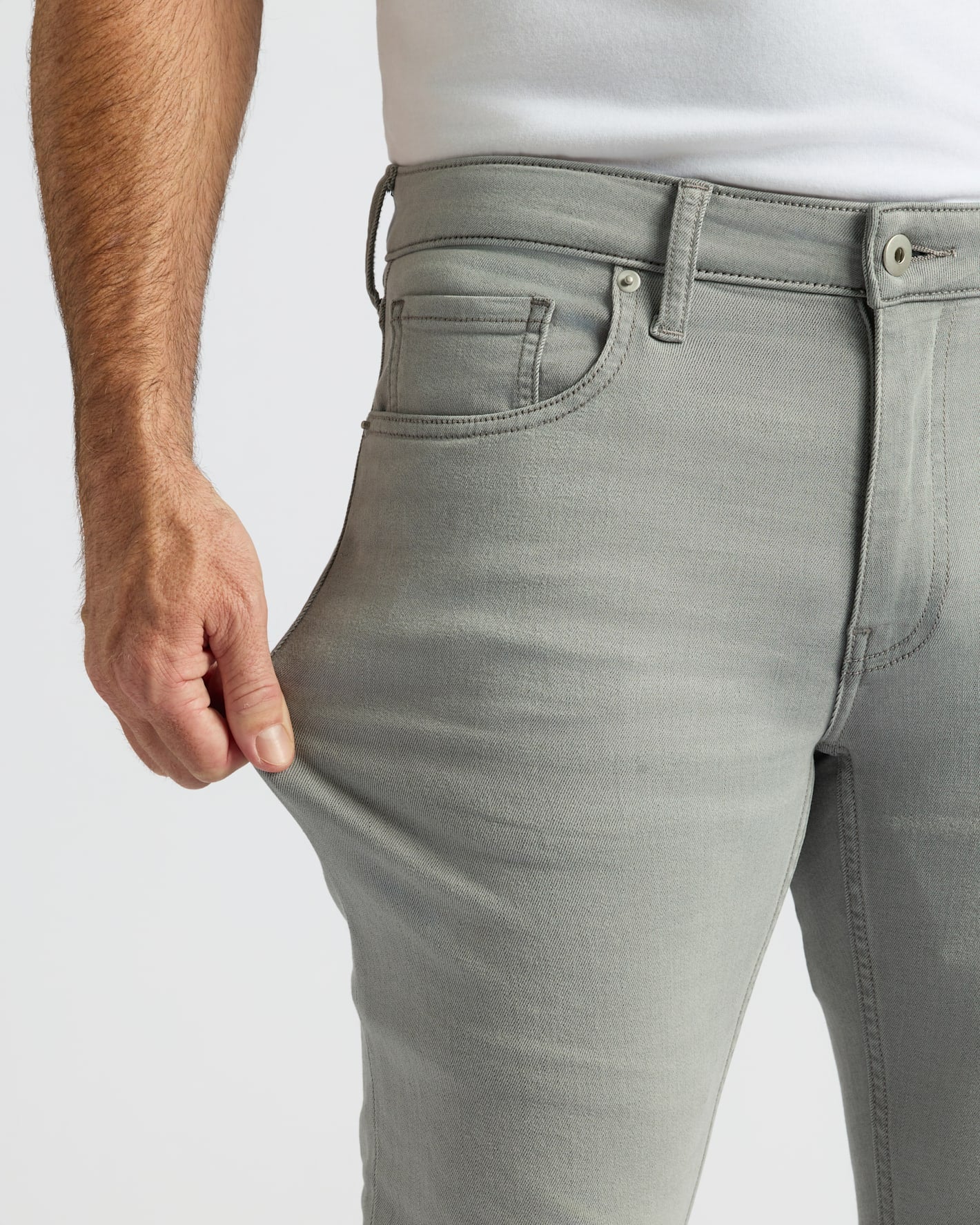 Man showing stretch of Medium Gray Wash Slim Comfort Stretch Jeans.