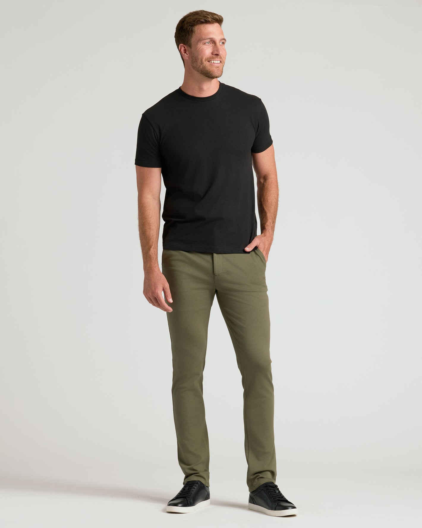 Man in Military Green Slim Comfort Knit Chino Pant, black t-shirt.