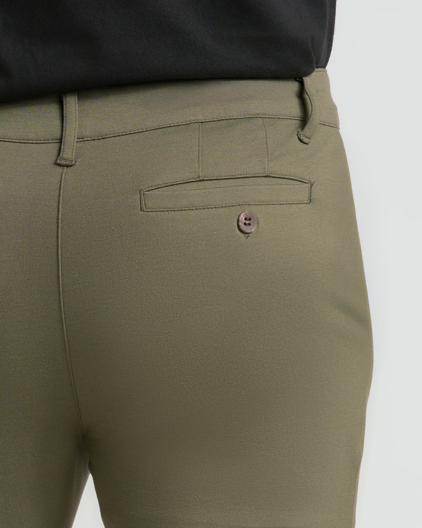 Military Green Slim Comfort Knit Chino Pant back view, showcasing buttoned welt pocket.