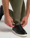 Military Green Slim Comfort Knit Chino Pant worn over black sneaker.