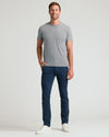 Man wearing Slim Comfort Knit Chino Pant, smiling in casual attire.