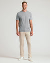 Man wearing Sandstone Comfort Chino Pants with gray T-shirt and sneakers.