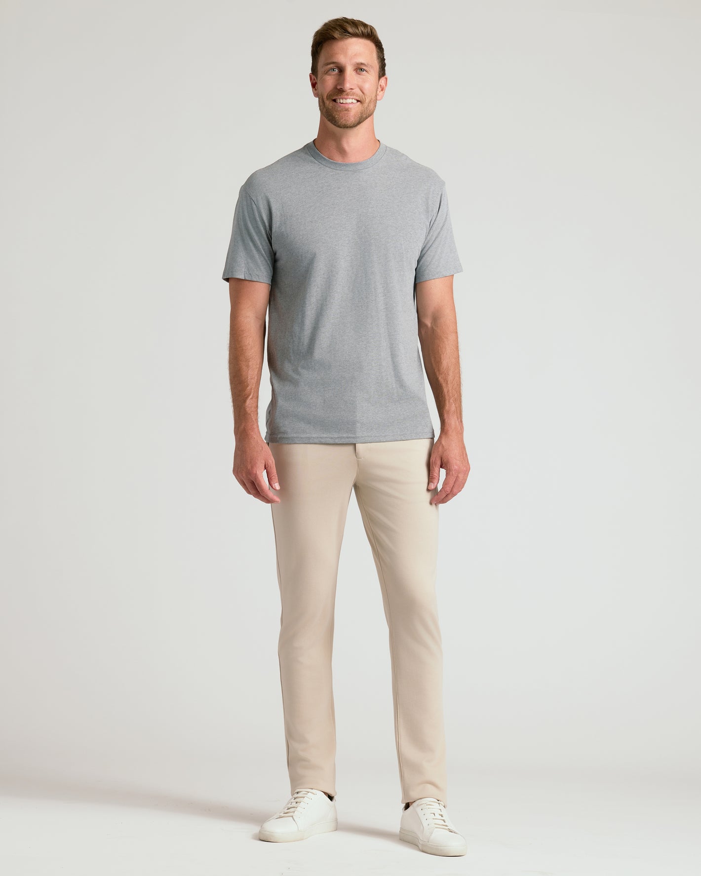 Man wearing Sandstone Comfort Chino Pants with gray T-shirt and sneakers.