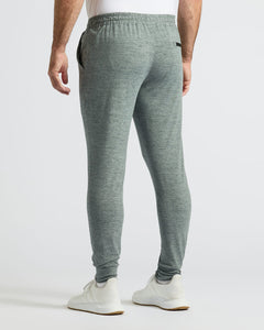 True ClassicHeather Gray Active Joggers modeled with white sneakers, studio setting.
