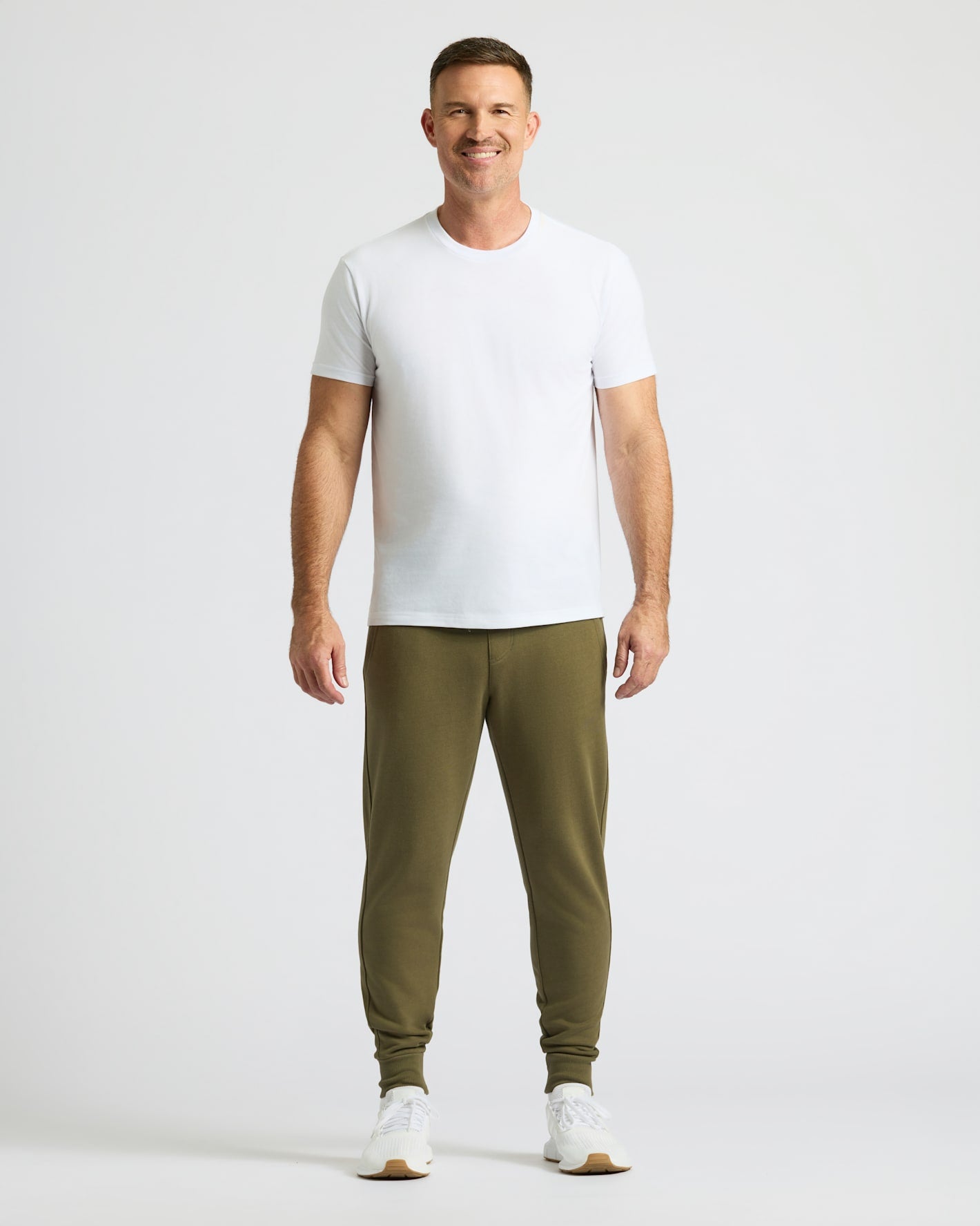 Man in Military Green Fleece French Terry Joggers, white T-shirt.
