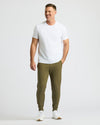 Man wearing Military Green Fleece French Terry Joggers with white T-shirt.