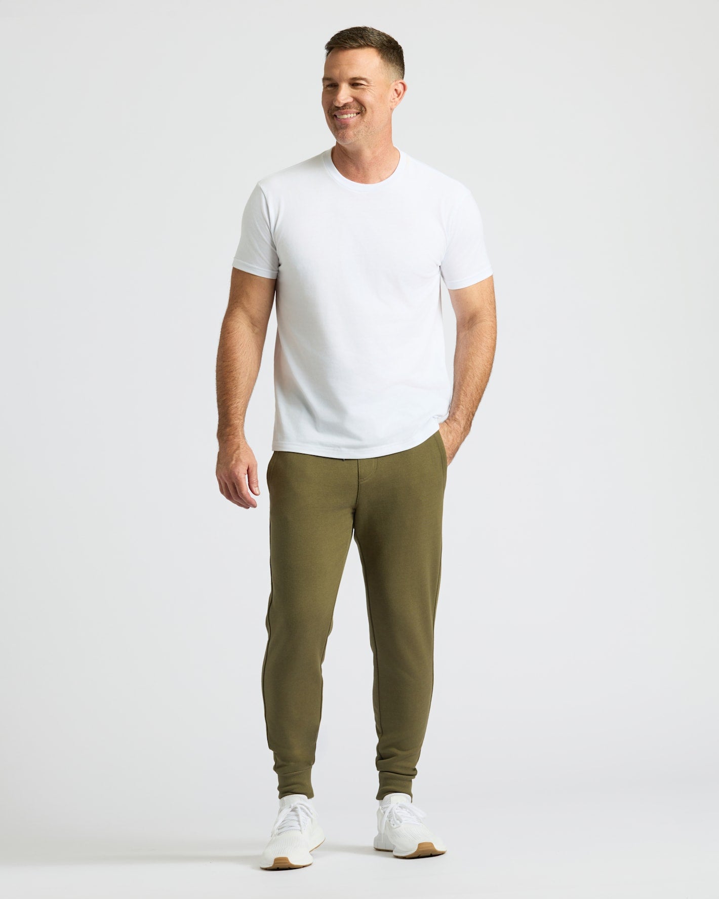 Man wearing Military Green Fleece French Terry Joggers with white T-shirt.