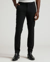 Black Commuter Pants with slim fit, worn with black Chelsea boots.