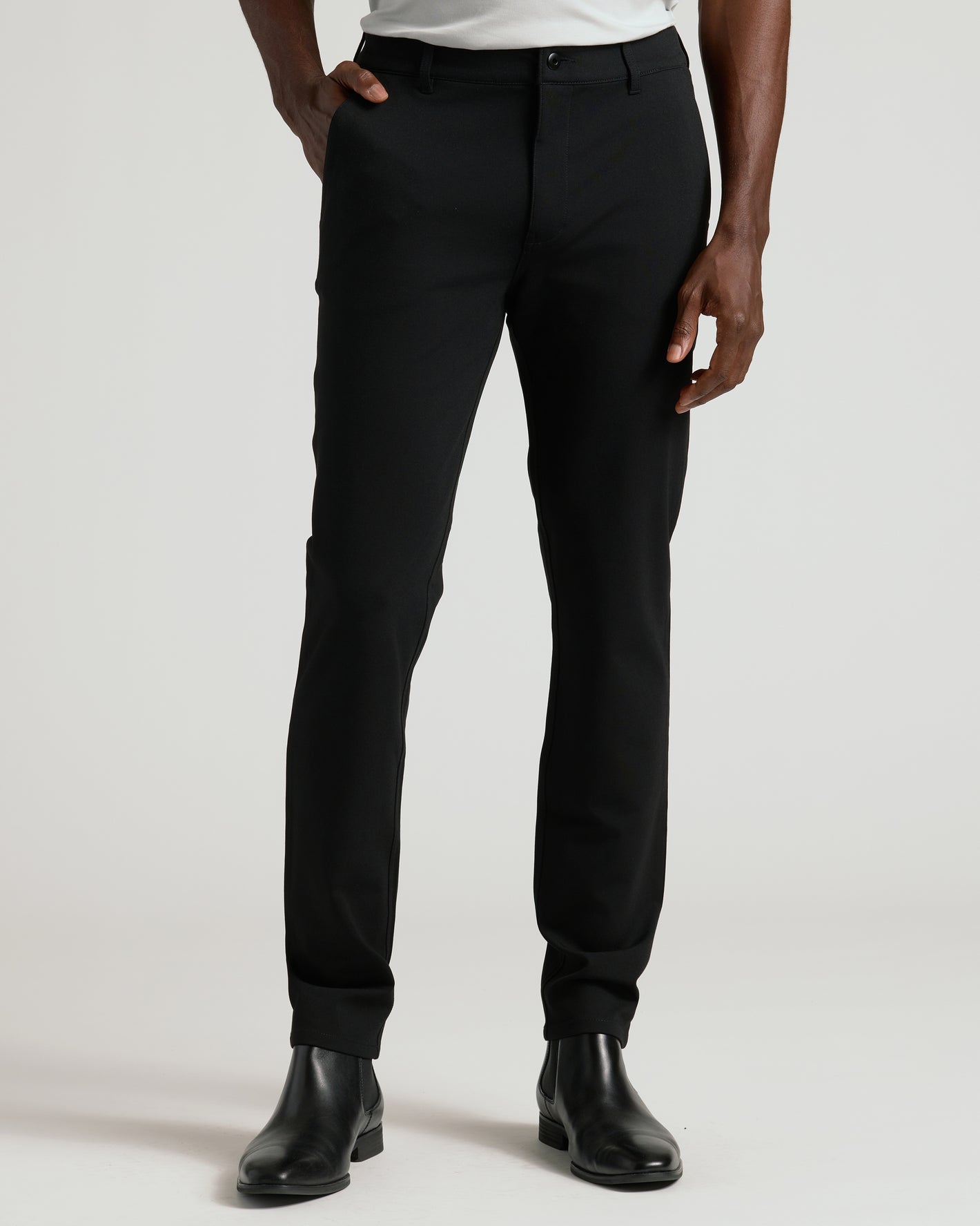 Black Commuter Pants with slim fit, worn with black Chelsea boots.