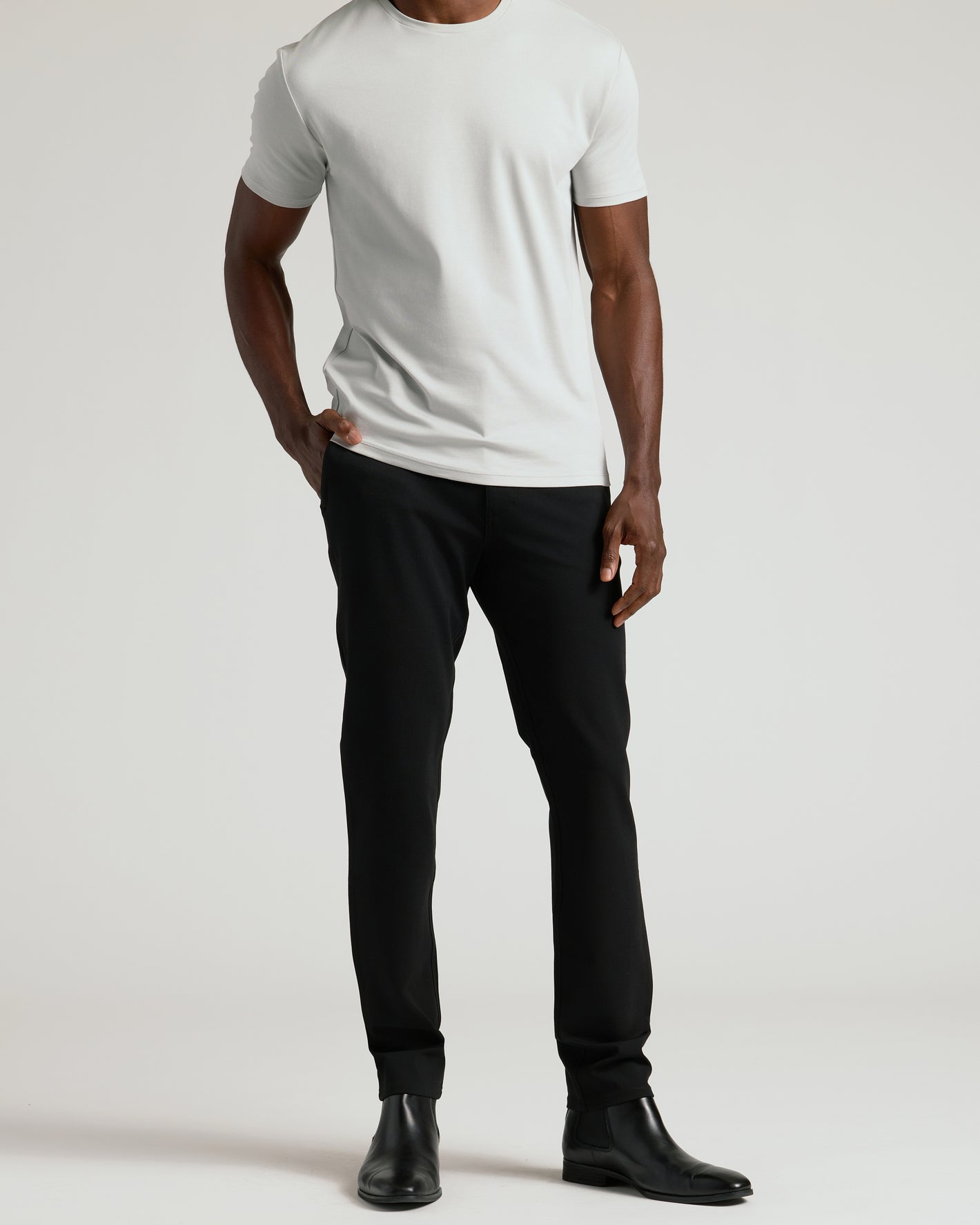 Black Commuter Pants with slim fit, worn with Chelsea boots.