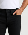 Black Wash Slim Authentic Denim Jeans with hand in front pocket.