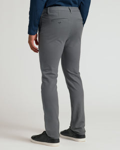 True ClassicPerson wearing Carbon Slim Chino Pants 2.0 with black sneakers.