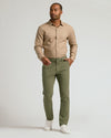 Model wearing Military Green Slim Chino Pants 2.0, mid-stride stance.
