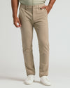 Khaki Straight Chino Pants 2.0 with white sneakers in studio setting.