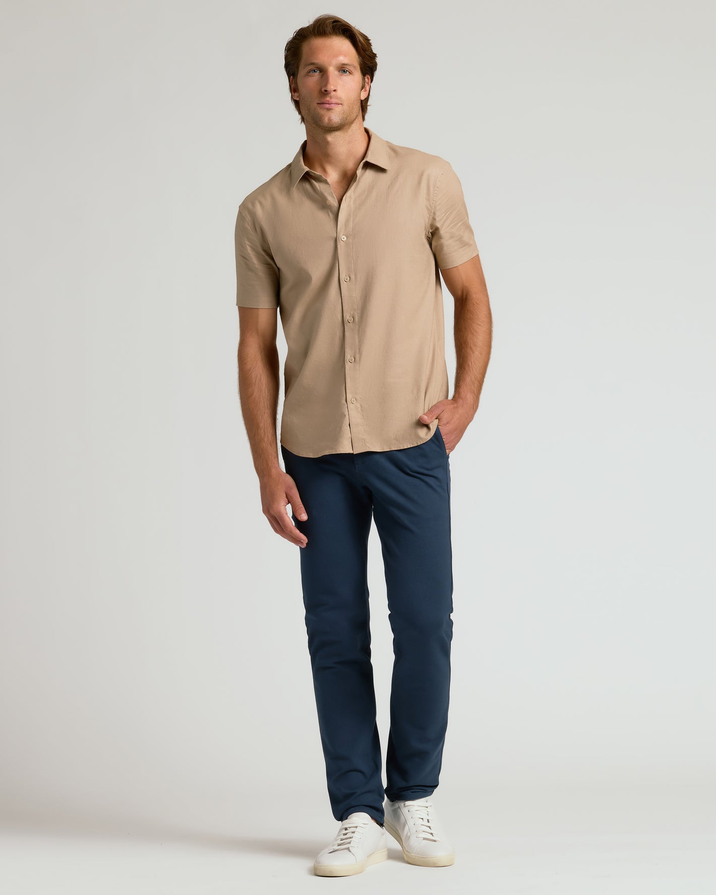 Man wearing Navy Slim Chino Pants 2.0, showcasing relaxed slim fit.