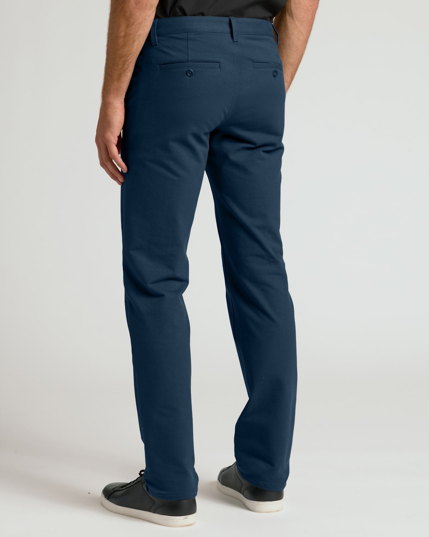 Navy Straight Chino Pants 2.0 with black sneakers, studio background.