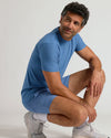 Man wearing Azul Active Quick Dry Shorts with Liner, crouching in studio.