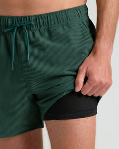 True Classic5 Marine Spruce Seersucker Swim Trunks with black compression liner visible.