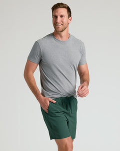 True ClassicMan wearing 7 Marine Spruce Seersucker Swim Trunks, smiling mid-stride.