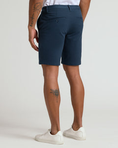 True Classic9 Navy Classic Chino Shorts 2.0 with sneakers, tattoos visible.