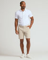 Model wearing 9 Sandstone Chino Shorts 2.0 with white shirt and sneakers.