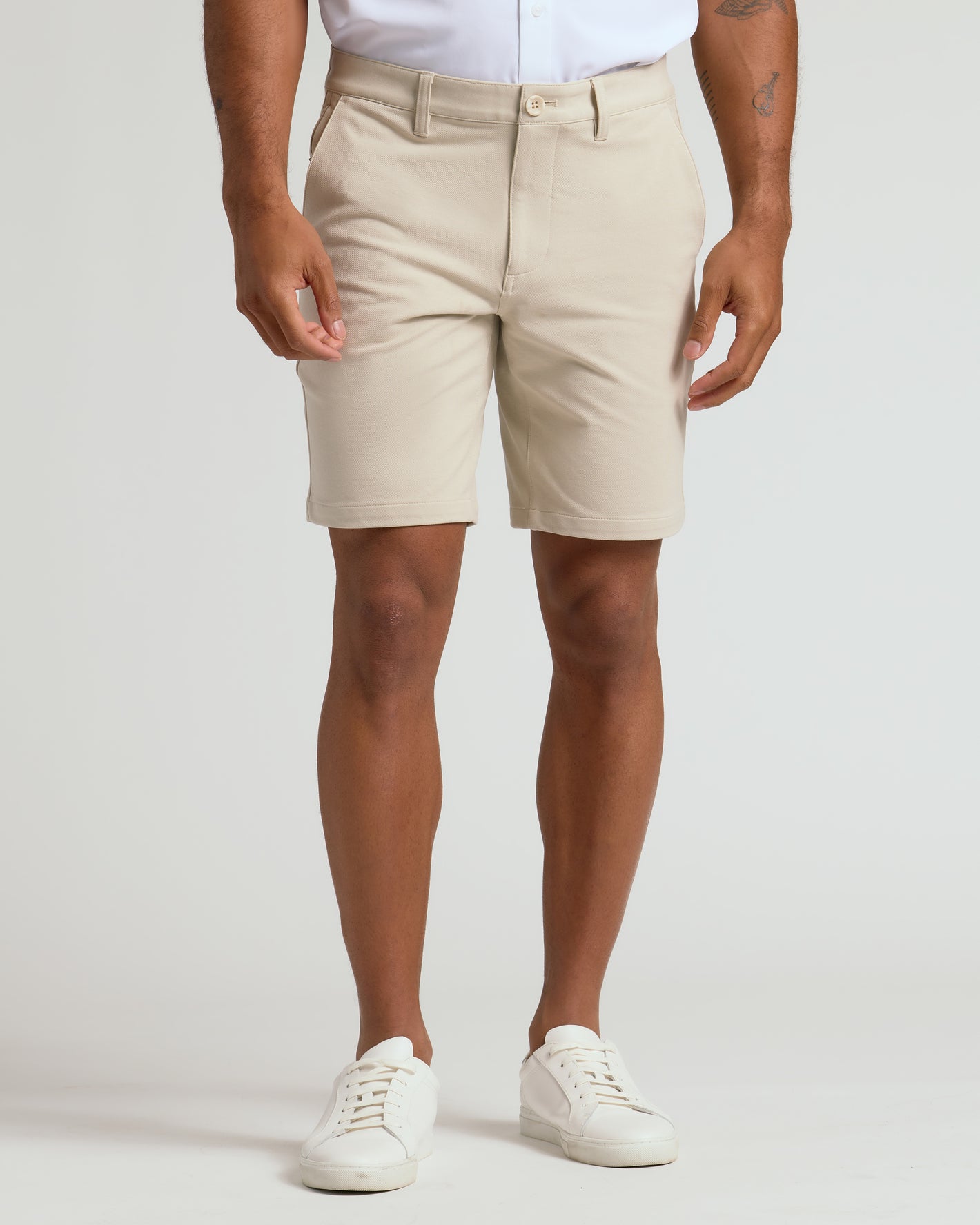 9 Sandstone Chino Shorts 2.0 on model with white sneakers.
