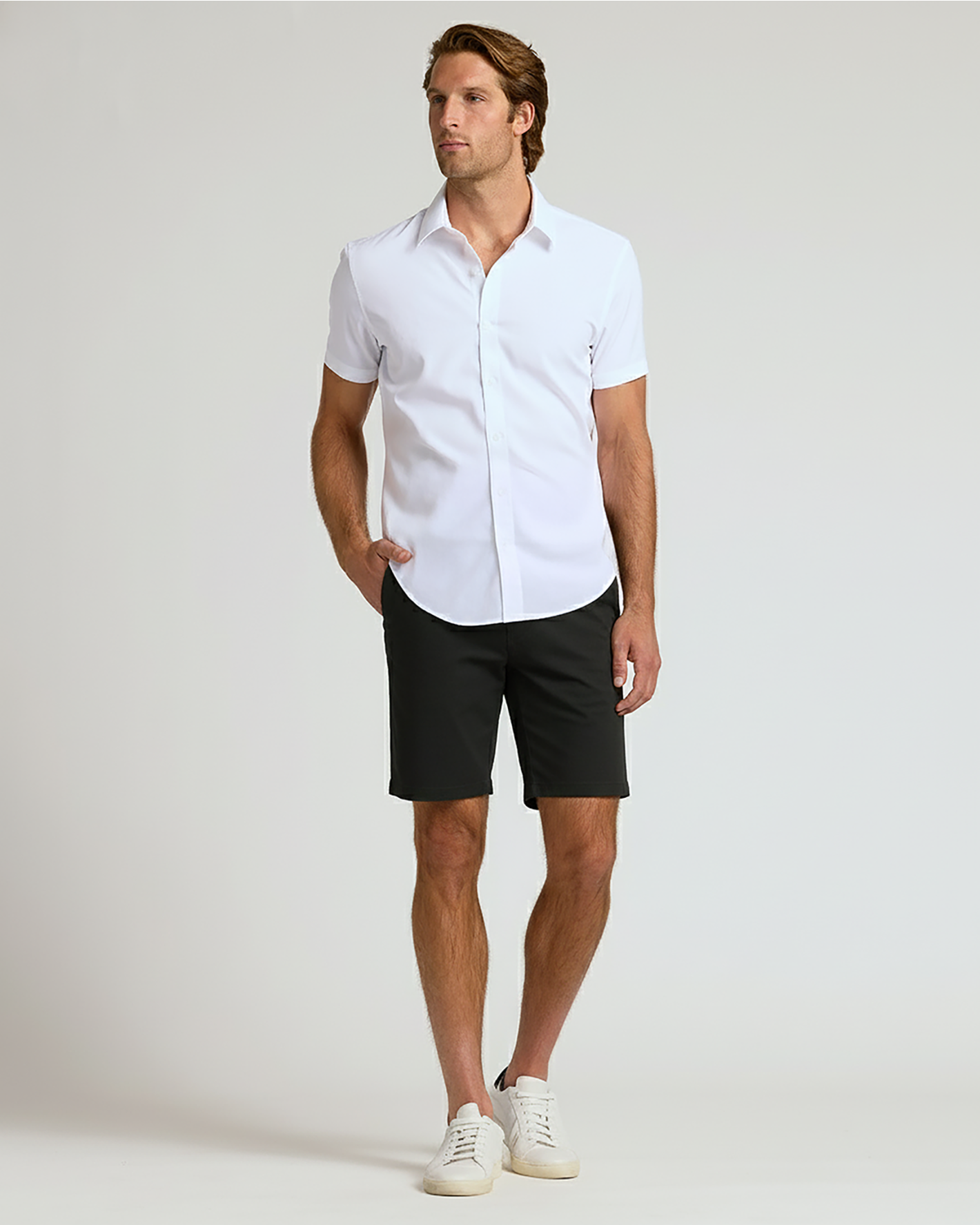 Man wearing 7 Black Chino Shorts 2.0 with white shirt.