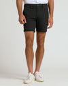Model in fitted 7 Black Chino Shorts with white sneakers.