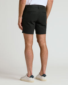 True Classic7 Black Chino Shorts 2.0, tailored, button-flap pockets, worn with sneakers.