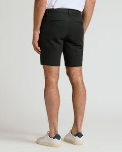 True ClassicMan wearing 7 Black Chino Shorts 2.0 and white sneakers, back view.
