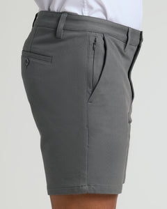 True Classic7 Carbon Chino Shorts 2.0, tailored mid-thigh, with zippered and buttoned pockets.