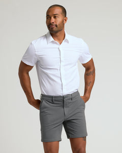True ClassicMan wearing 7 Carbon Chino Shorts 2.0 with white shirt, hands in pockets.