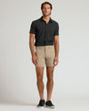 Man wearing 7 Khaki Chino Shorts 2.0 with black shirt.